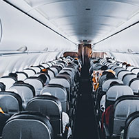 Plane seats with people from the back of a plane